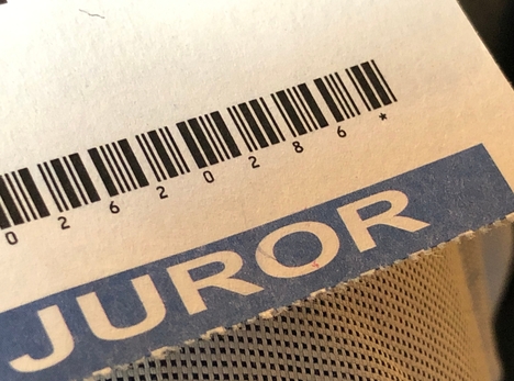 The word "juror" and a barcode on a piece of paper.