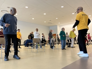 A large groups of seniors taking dance lessons in the Oak Park Michigan Community Center.